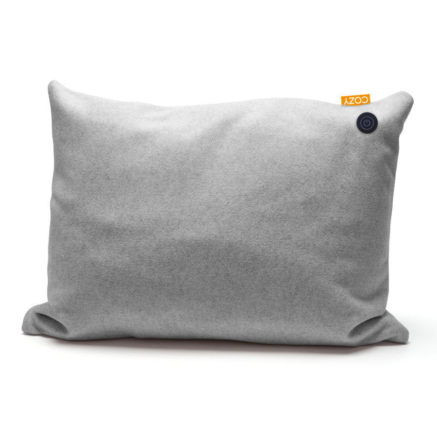 The COZY Heated Cushion Cordless - TOVE (60cm x 45cm) by Cozy Cushion EU is a rectangular light gray cushion featuring a small orange COZY tag and a round black button at the upper right, displayed on a white background.
