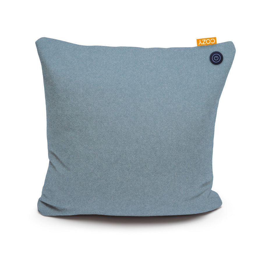 The COZY Heated Cushion Cordless - UNA (45cm x 45cm) by Cozy Cushion EU is a square, light blue cushion with a small orange COZY tag and round black button in the top right corner, shown on a plain white background.