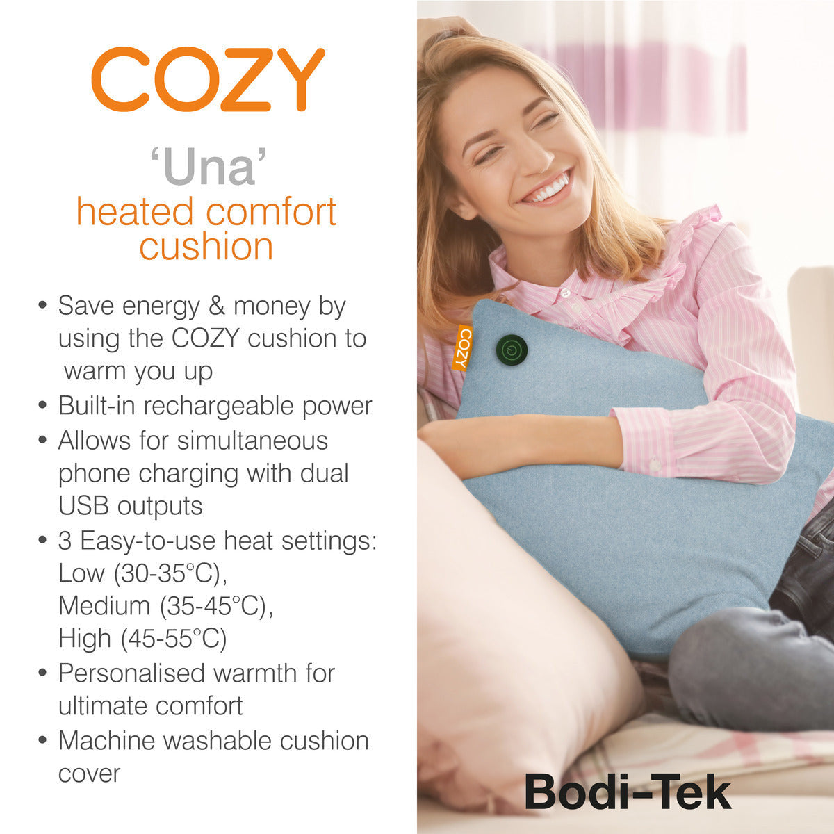 A smiling woman sits on a couch, hugging the COZY Heated Cushion Cordless - UNA (45cm x 45cm) by Cozy Cushion EU. Features include energy saving, USB charging, three heat settings, infrared warmth, and a washable cover.