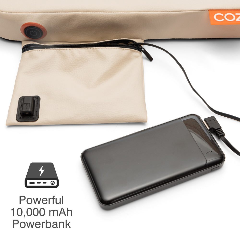 A black powerbank connected with a cable rests beside a beige zippered pouch, ready to charge your COZY Cordless Heated Seat Pad - JORD by Cozy Cushion EU. The text “Powerful 10,000 mAh Powerbank” and a battery icon are displayed below.