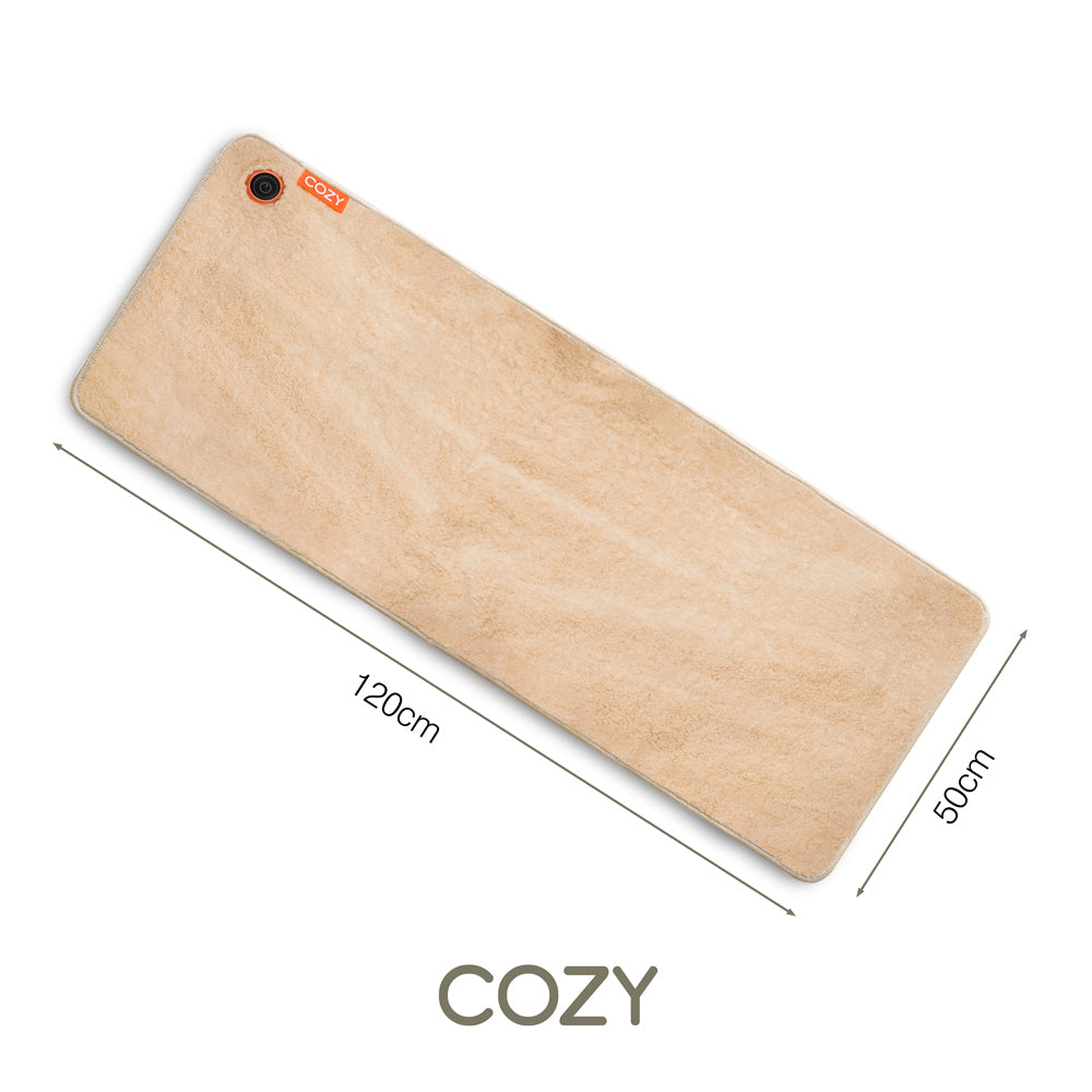 The COZY Heated Throw & Seat Cover Pad - JORV by Cozy Cushion EU is a rectangular beige mat (120 x 50 cm) with a soft texture, small orange label, and COZY in one corner. This eco-friendly heating pad adds extra comfort to any space.
