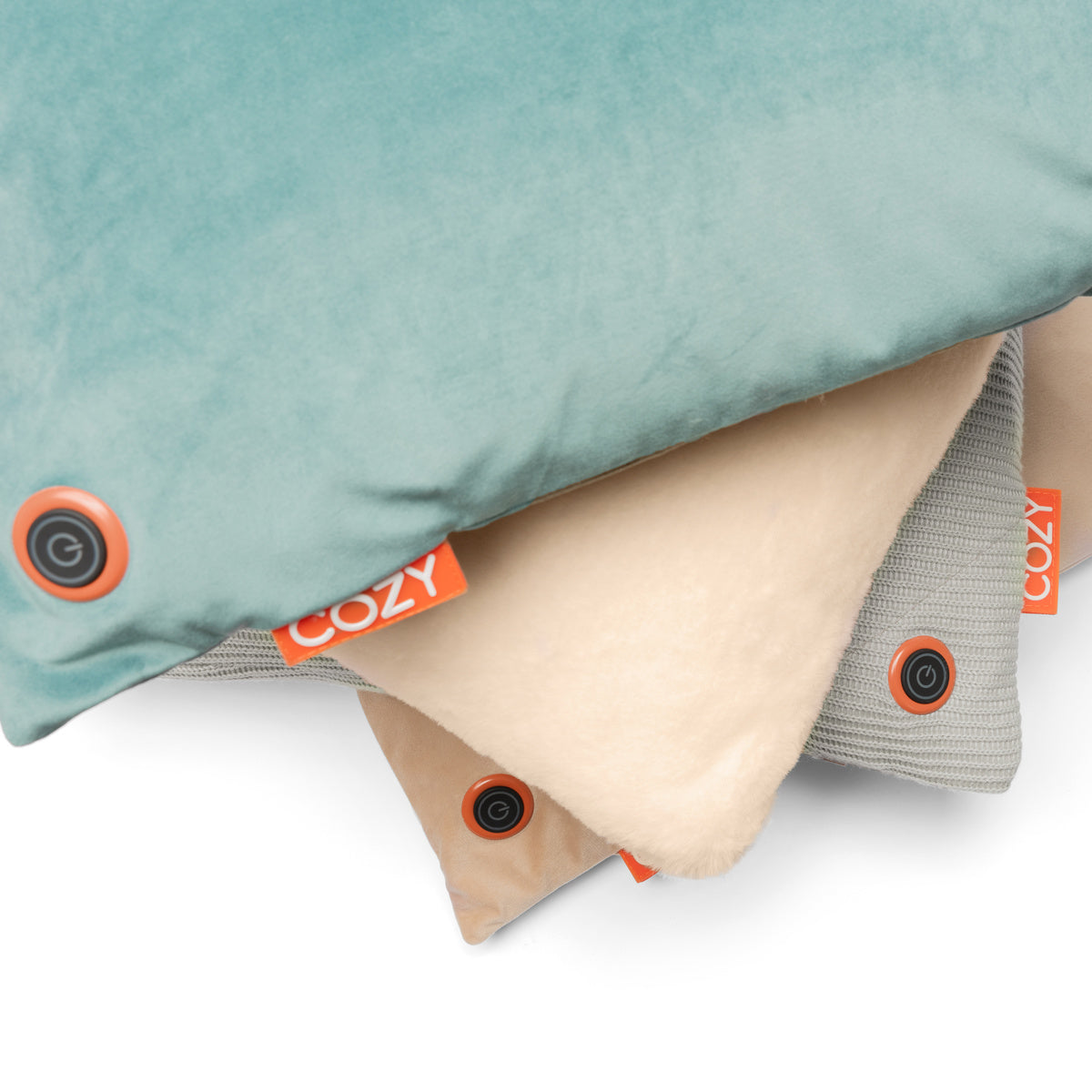The COZY Heated Cushion Cordless - UNA Knitted (45cm x 45cm) by Cozy Cushion EU features soft teal, cream, and light gray squares with a black power button and orange COZY tag—offering cordless warmth via built-in rechargeable battery.