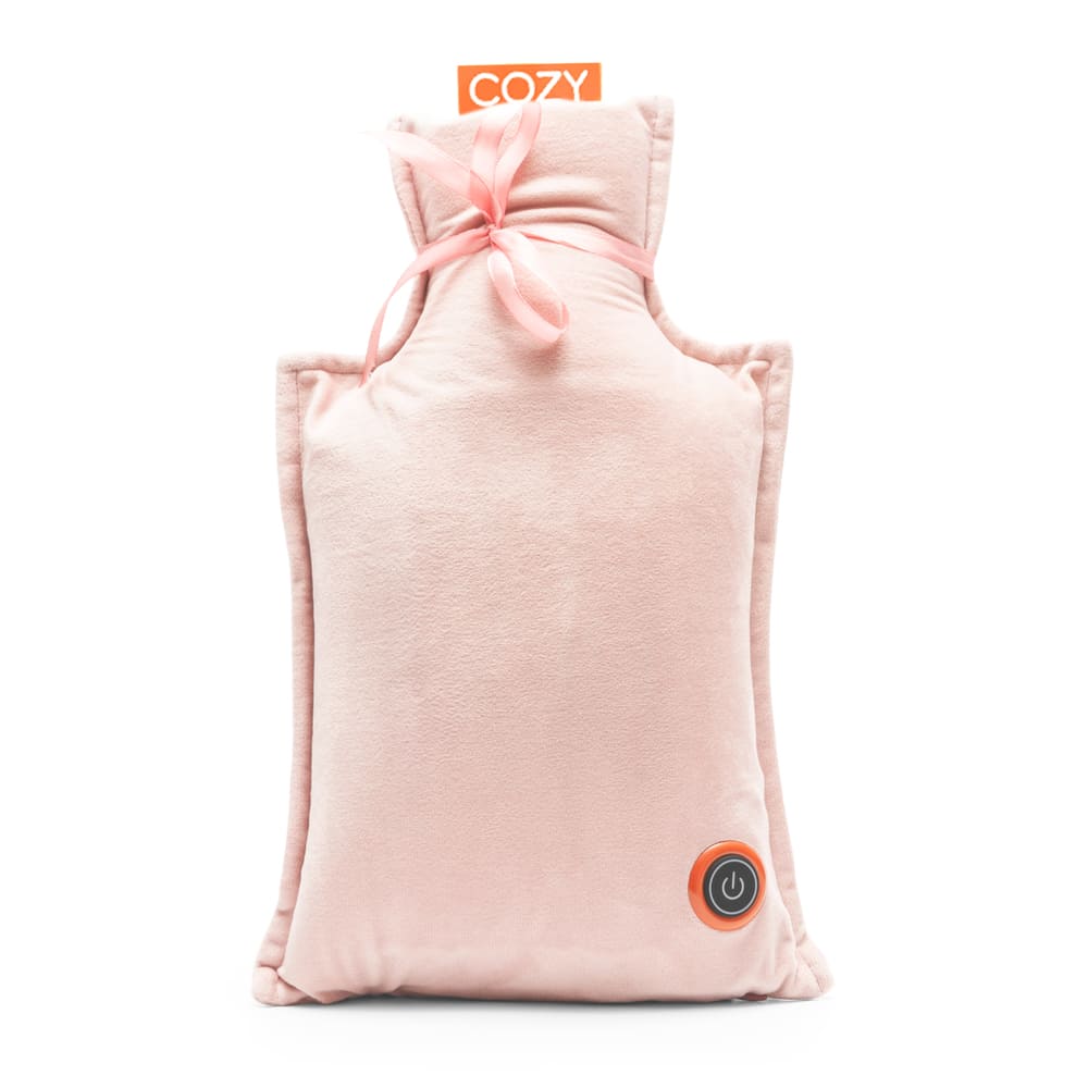 The UNA Rechargeable Hot Water Bottle by Cozy Cushion EU is a soft, rectangular light pink cushion with a tied bow at the top, black power button near the bottom corner, and an orange COZY tag—offering stylish wireless warmth.